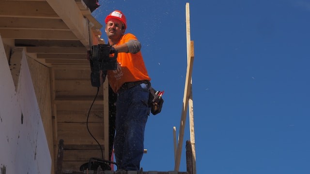 person on the roof cutting