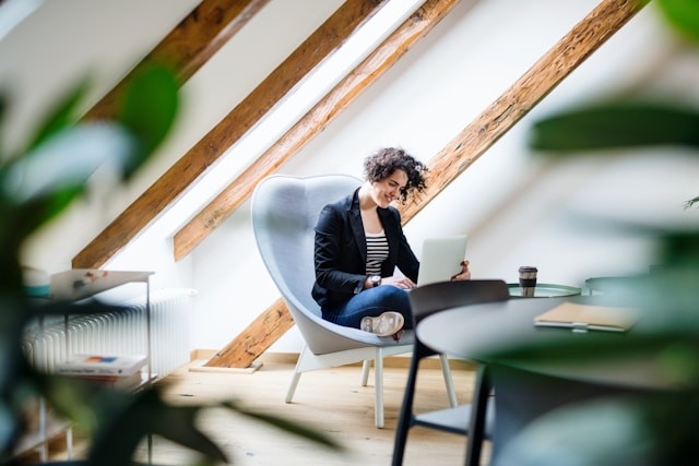 a woman sits in the attic and works